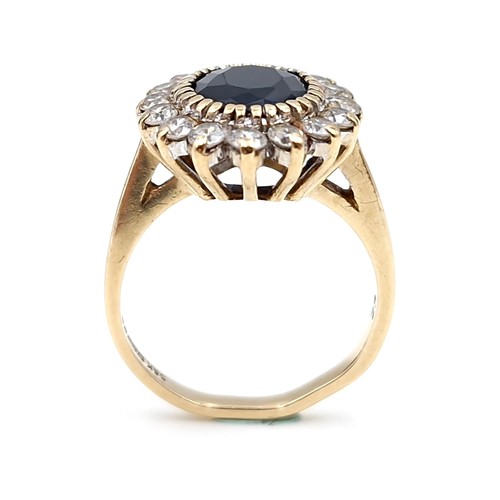 10 - Star lot : A stunning nine carat gold sapphire stone ring set with cubic zirconia surround. Ring siz... 