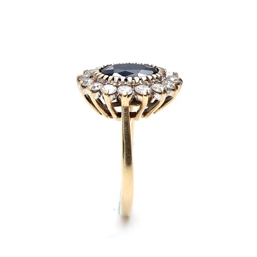 10 - Star lot : A stunning nine carat gold sapphire stone ring set with cubic zirconia surround. Ring siz... 