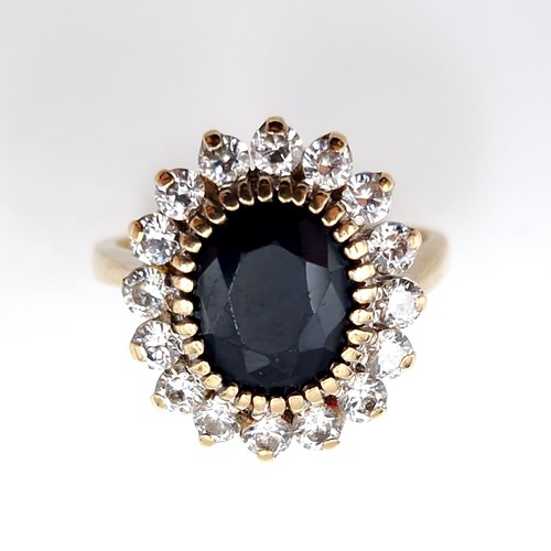 10 - Star lot : A stunning nine carat gold sapphire stone ring set with cubic zirconia surround. Ring siz... 