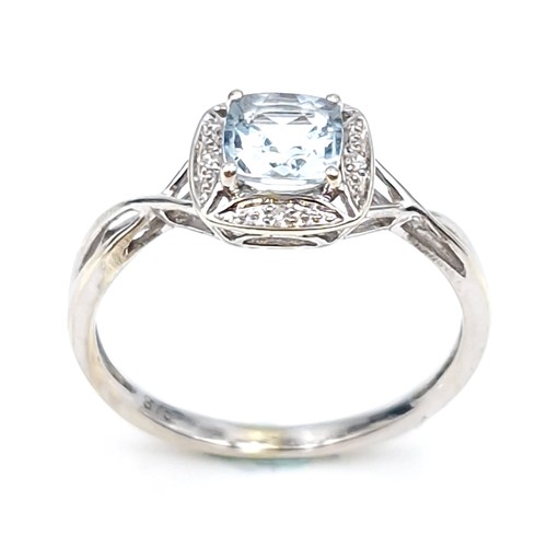 12 - Star lot : A lovely nine carat white gold aquamarine gemstone ring set diamonds  with a twist mount.... 