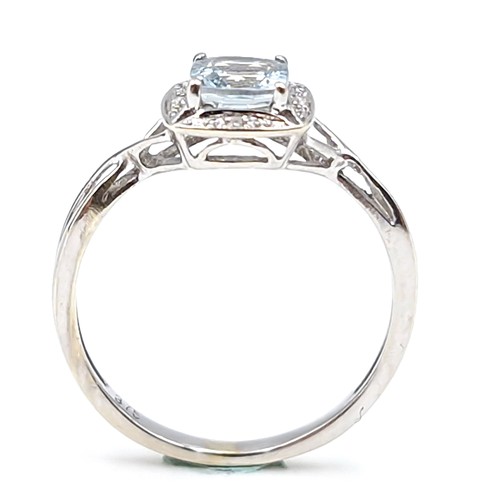 12 - Star lot : A lovely nine carat white gold aquamarine gemstone ring set diamonds  with a twist mount.... 