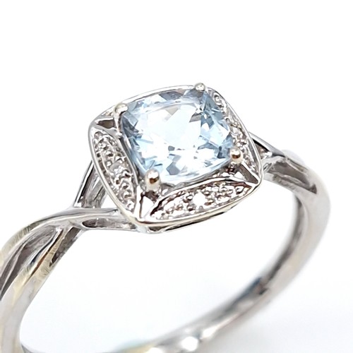 12 - Star lot : A lovely nine carat white gold aquamarine gemstone ring set diamonds  with a twist mount.... 