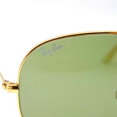 16 - A pair of Ray-Ban gold framed aviator style sunglasses. Lenses clear. Comes in original case.