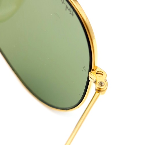 16 - A pair of Ray-Ban gold framed aviator style sunglasses. Lenses clear. Comes in original case.