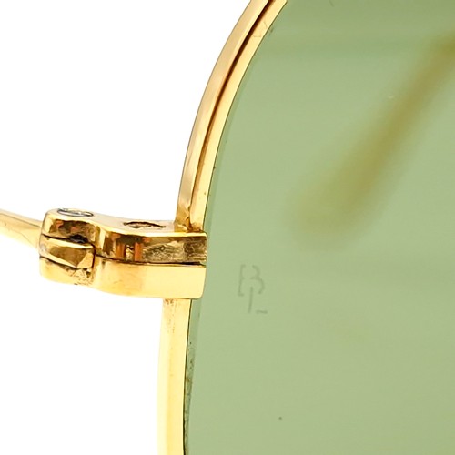 16 - A pair of Ray-Ban gold framed aviator style sunglasses. Lenses clear. Comes in original case.