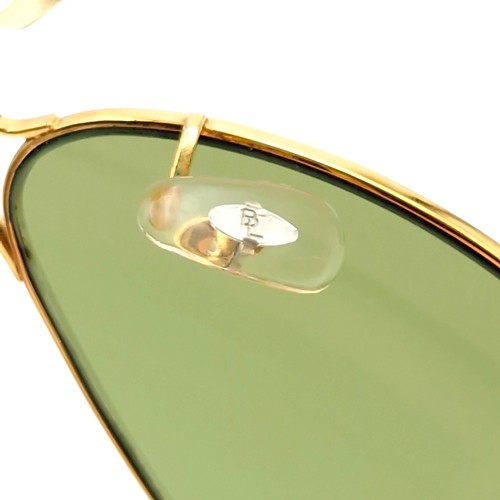 16 - A pair of Ray-Ban gold framed aviator style sunglasses. Lenses clear. Comes in original case.