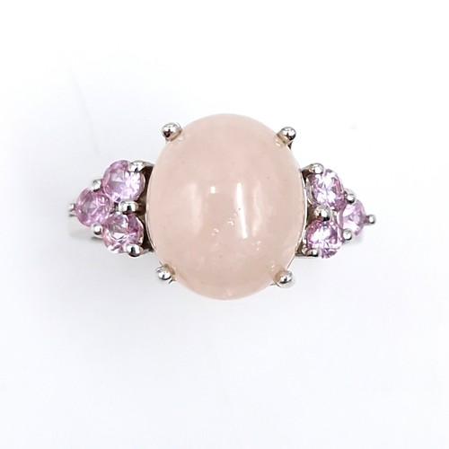 27 - A lovely pink rose quartz cabochon stone ring with gem set accents mounted in sterling silver. Size ... 