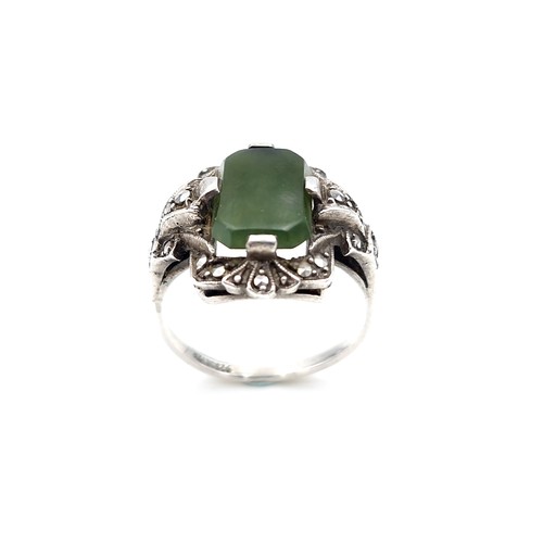 409 - A vintage jade stone ring set with marcasite detailing. Size - N. Weight - 5.64 grams.