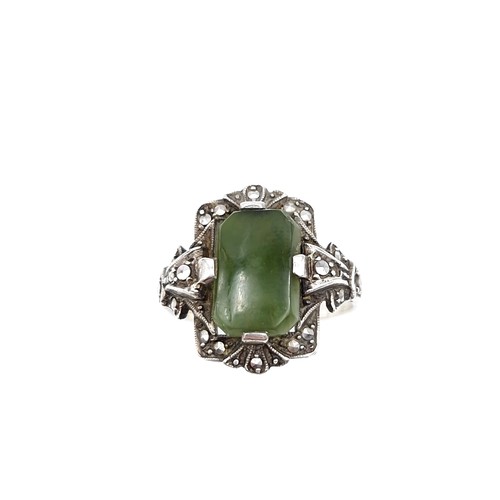 409 - A vintage jade stone ring set with marcasite detailing. Size - N. Weight - 5.64 grams.