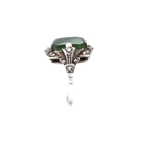 409 - A vintage jade stone ring set with marcasite detailing. Size - N. Weight - 5.64 grams.