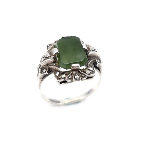 409 - A vintage jade stone ring set with marcasite detailing. Size - N. Weight - 5.64 grams.