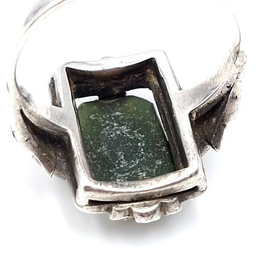 409 - A vintage jade stone ring set with marcasite detailing. Size - N. Weight - 5.64 grams.