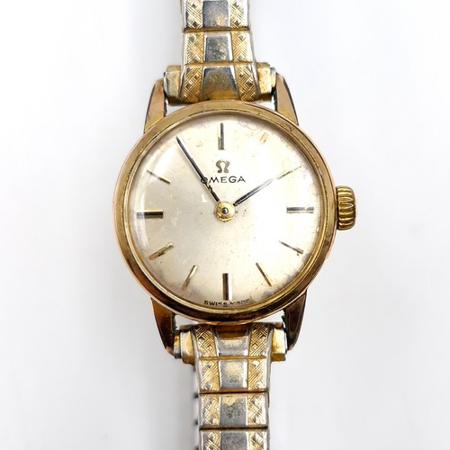 413 - Star Lot : A vintage Omega ladies wristwatch with gold toned case set with patterned hands and exten... 