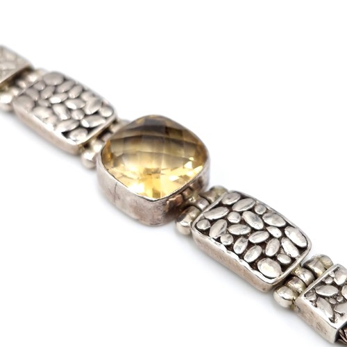 414 - A beautiful example of an antique sterling silver bracelet with three mounted citrine gemstones with... 