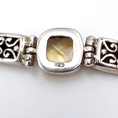 414 - A beautiful example of an antique sterling silver bracelet with three mounted citrine gemstones with... 