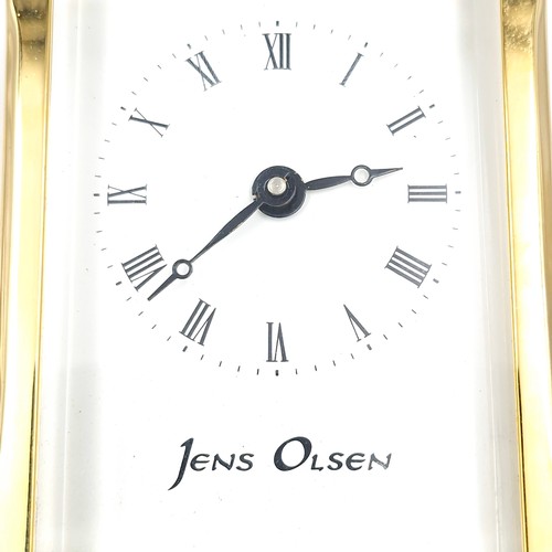 421 - A lovely example of a brass carriage clock by Jens Olsen with inspection aperture set with white ena... 