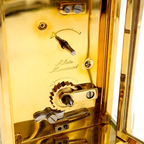 421 - A lovely example of a brass carriage clock by Jens Olsen with inspection aperture set with white ena... 