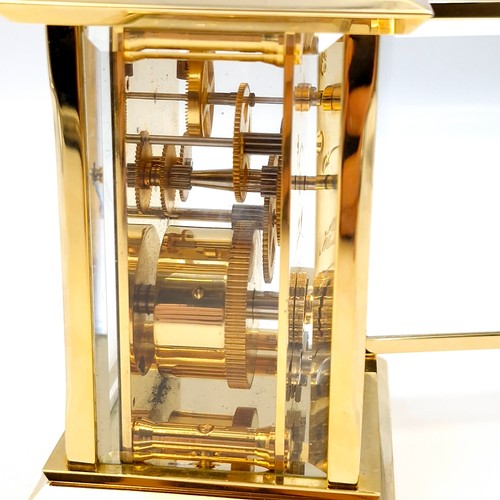 421 - A lovely example of a brass carriage clock by Jens Olsen with inspection aperture set with white ena... 