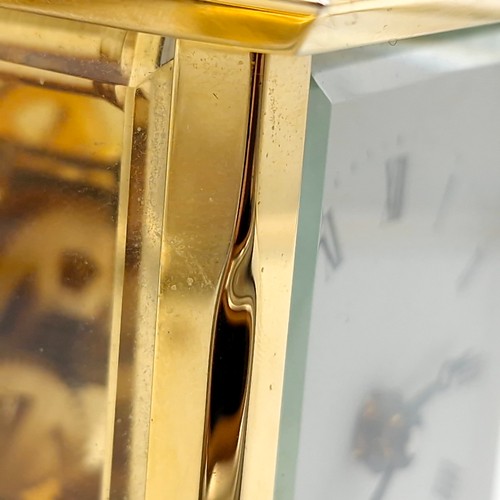 421 - A lovely example of a brass carriage clock by Jens Olsen with inspection aperture set with white ena... 