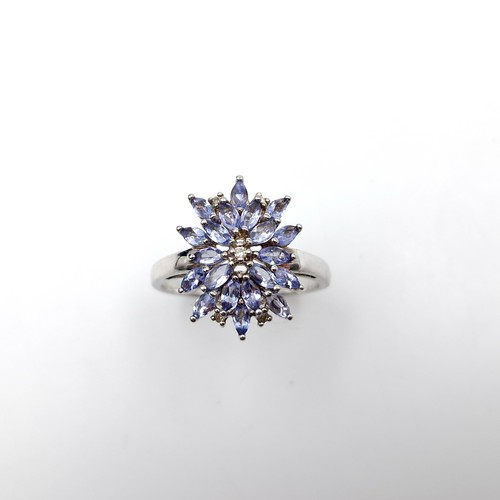 435 - A Tanzanite & diamond cluster ring set in sterling silver. Size - W. Weight - 4.7 grams. Boxed. Ring... 