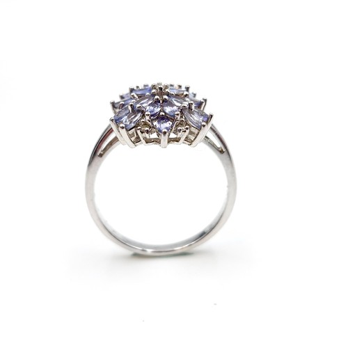 435 - A Tanzanite & diamond cluster ring set in sterling silver. Size - W. Weight - 4.7 grams. Boxed. Ring... 