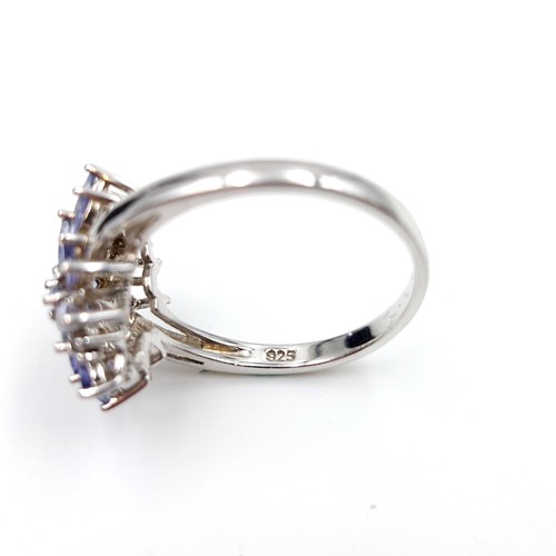 435 - A Tanzanite & diamond cluster ring set in sterling silver. Size - W. Weight - 4.7 grams. Boxed. Ring... 