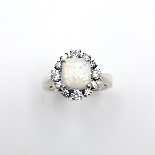 436 - A beautiful square raised opal stone ring with gemstone surround. Size - P. Weight - 4.2 grams. Boxe... 