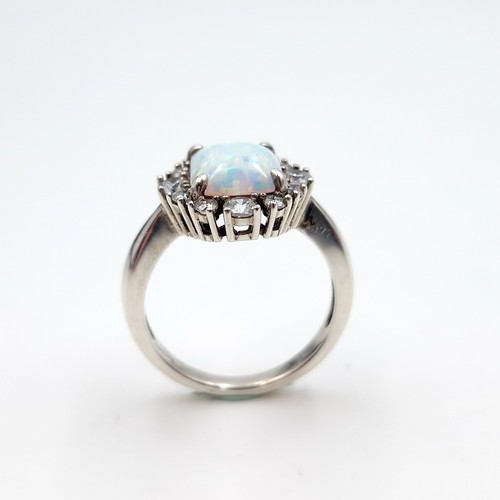 436 - A beautiful square raised opal stone ring with gemstone surround. Size - P. Weight - 4.2 grams. Boxe... 