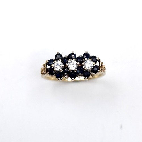 1118 - A pretty vintage sapphire ring with three gemstone accents mounted in nine carat gold. Ring size - K... 