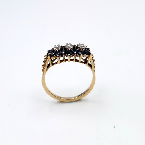 1118 - A pretty vintage sapphire ring with three gemstone accents mounted in nine carat gold. Ring size - K... 