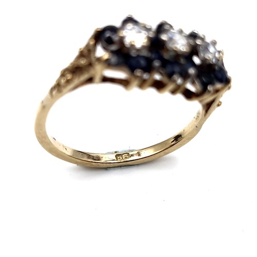 1118 - A pretty vintage sapphire ring with three gemstone accents mounted in nine carat gold. Ring size - K... 