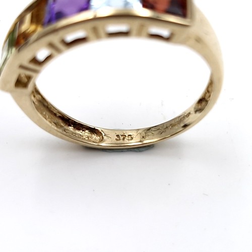 1119 - A vari hue gemset ring mounted in nine carat gold (375). Ring size - N. Weight - 2.12 grams. Boxed.