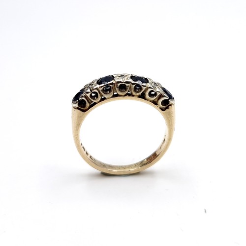 1120 - Star Lot : A pretty four stone sapphire ring with diamonds set in nine carat gold (375). Ring size -... 