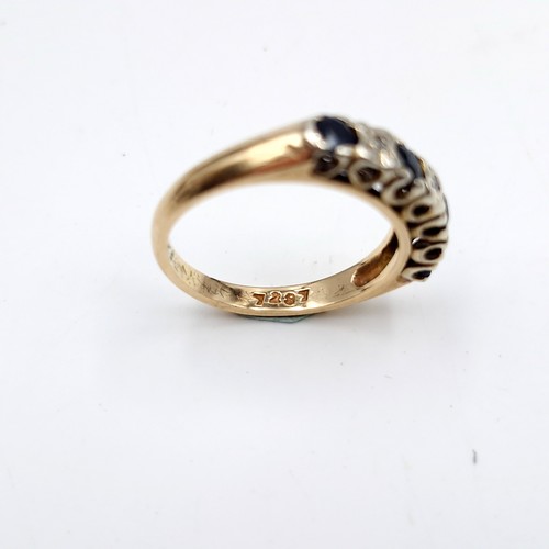 1120 - Star Lot : A pretty four stone sapphire ring with diamonds set in nine carat gold (375). Ring size -... 