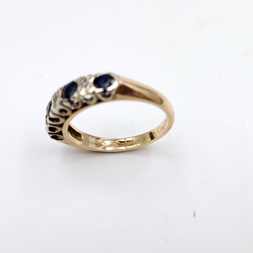 1120 - Star Lot : A pretty four stone sapphire ring with diamonds set in nine carat gold (375). Ring size -... 