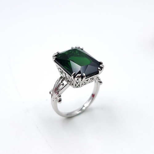 13 - A beautiful sterling silver Scottish green tourmaline  ring set with foliate mount. Ring size - U. W... 