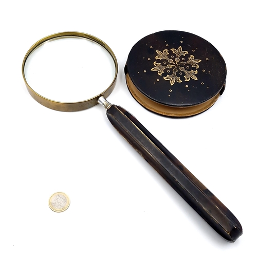 23 - An antique  oversized magnifying glass set a brass mount with a feruled handle. Total length - 33cm.... 