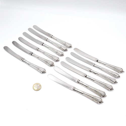 3 - A set of 12 kings pattern butter knives with sterling silver handles, hallmarked London.