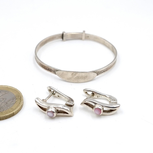 57 - A sterling silver childs bracelet together with a pair of silver gem set earrings, suitable for pier... 