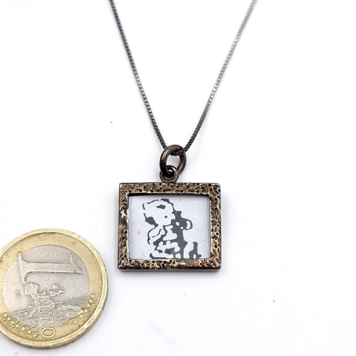 58 - A sterling silver pendant and chain with a Banksy style pendent. Length - 44cm. Weight - 7.2 grams. ... 