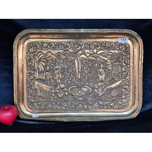 133 - A highly impressive antique hammered brass serving tray depicting traditional Persian scenery in hig... 