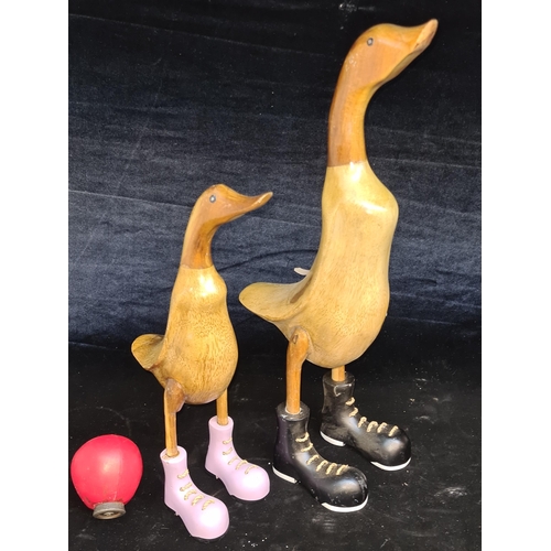 149 - A pair of tall wooden ducks with black and lilac heavy boots. Great fun and would be fun feature any... 