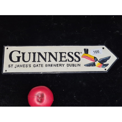 166 - A cast metal wall plaque in the form of a direction sign advertising Guinness.