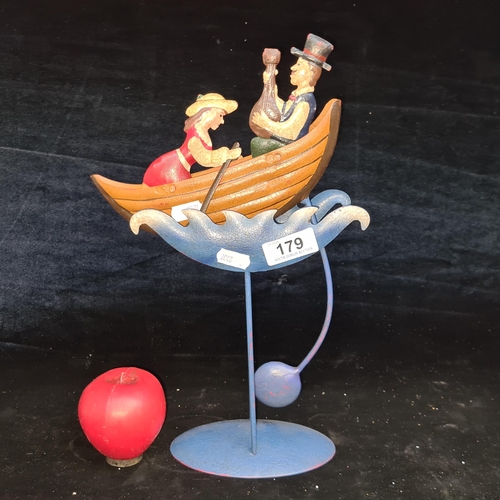 179 - A charming unique metal rocking couple on a rowing boat, balancing on a fulcrum.