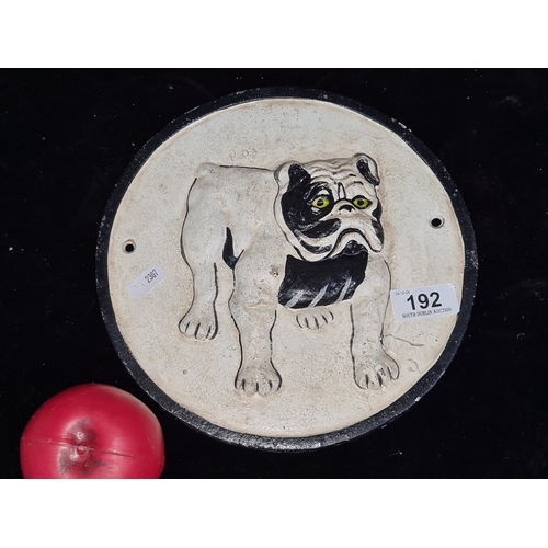 192 - A heavy cast metal round wall plaque featuring a bulldog.