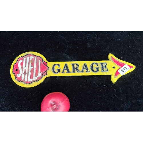 210 - A heavy cast metal wall plaque advertising Shell Garage Motor Oil.