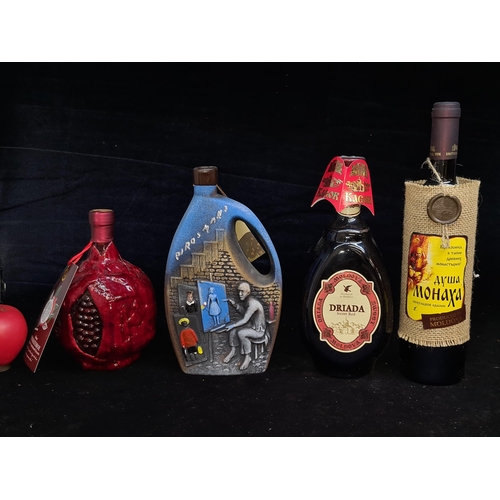 218 - Four sealed bottles of wine including two Moldovan examples, a Russian pomegranate example in a souv... 