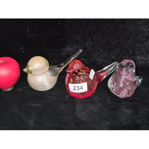 234 - A trio of charming heavy hand blown glass paperweights in the form of birds.