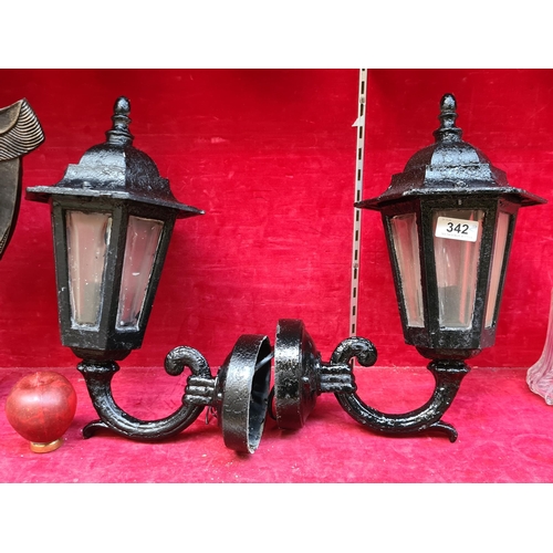 342 - A pair of outdoor cast metal wall lamps.