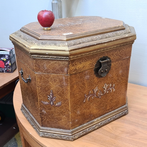 A large and impressive lidded storage/blanket box featuring gilt gold foliate detail, large brass hinge and handles, as well as hand painted fluer de lis decoration.